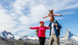 Couple with child in the Swiss mountains.